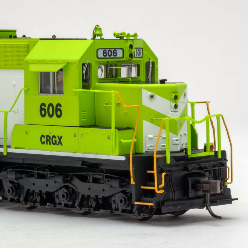 Color photo showing nose of HO scale six-axle hood unit painted bright green and white with black graphics on white background.