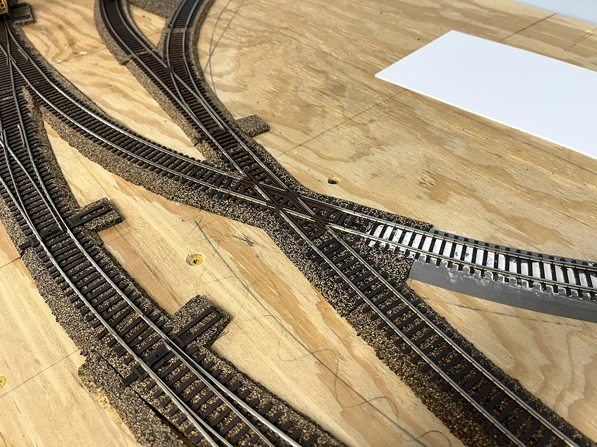Cork roadbed under model rail tracks on an under-construction model railroad layout