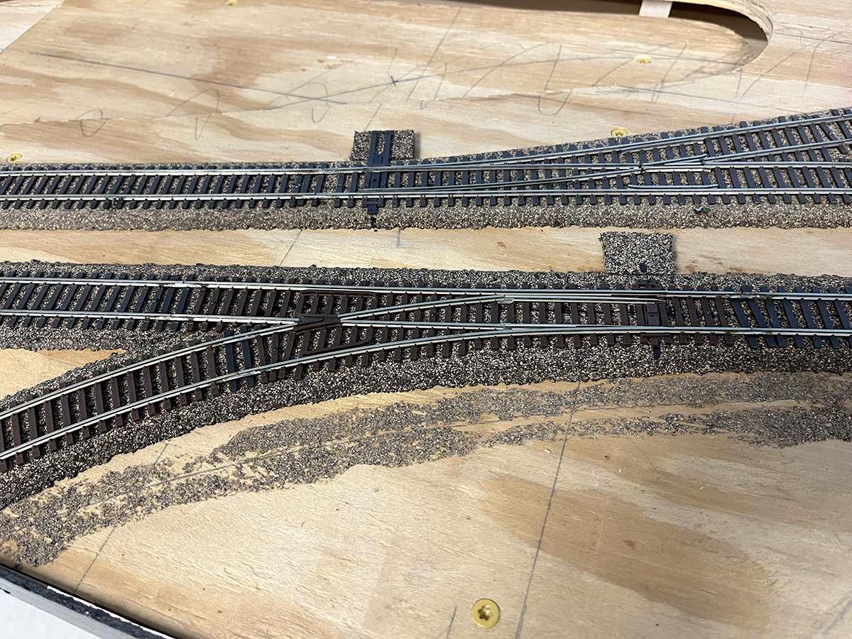 Cork roadbed under model rail tracks on an under-construction model railroad layout