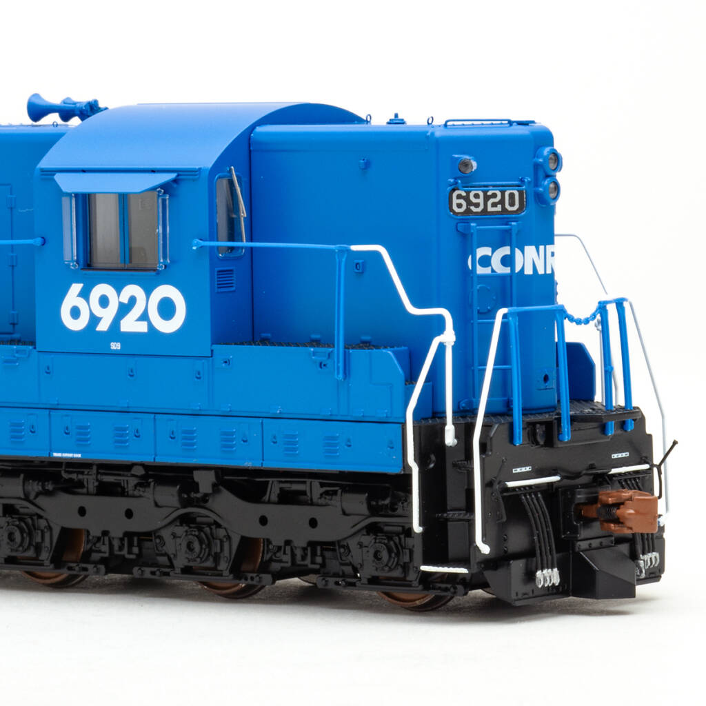Color photo showing cab and short hood of HO scale six-axle EMD hood unit painted blue with white graphics on white background.