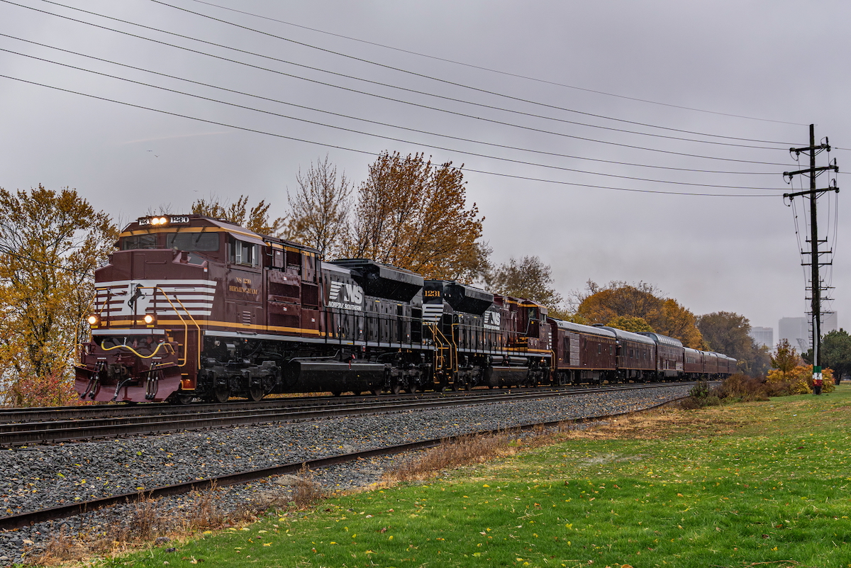 Tuscan red and black diesels with office car train