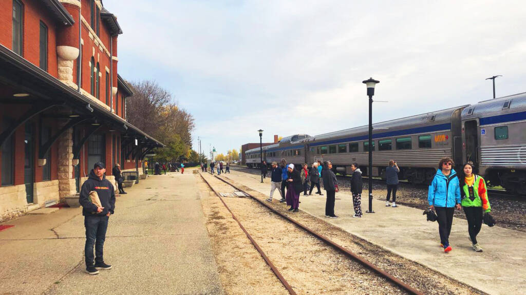 Streamlined passenger train stopped at station.
