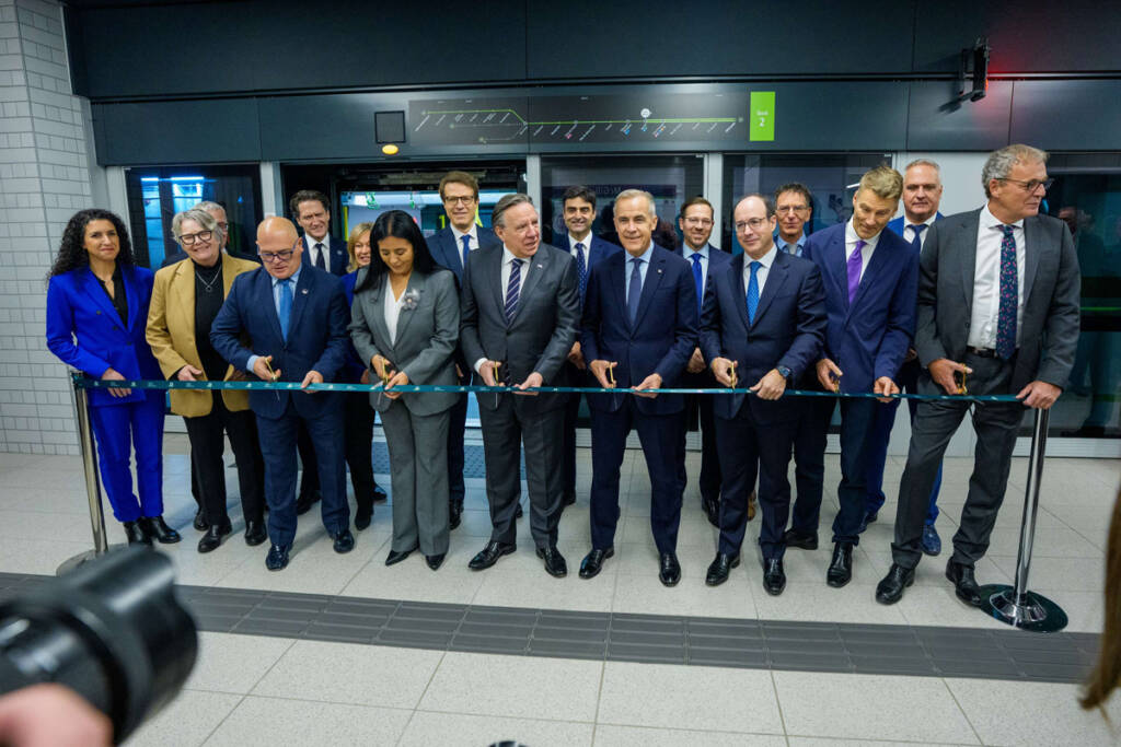 Group of people participating in ribbon cutting