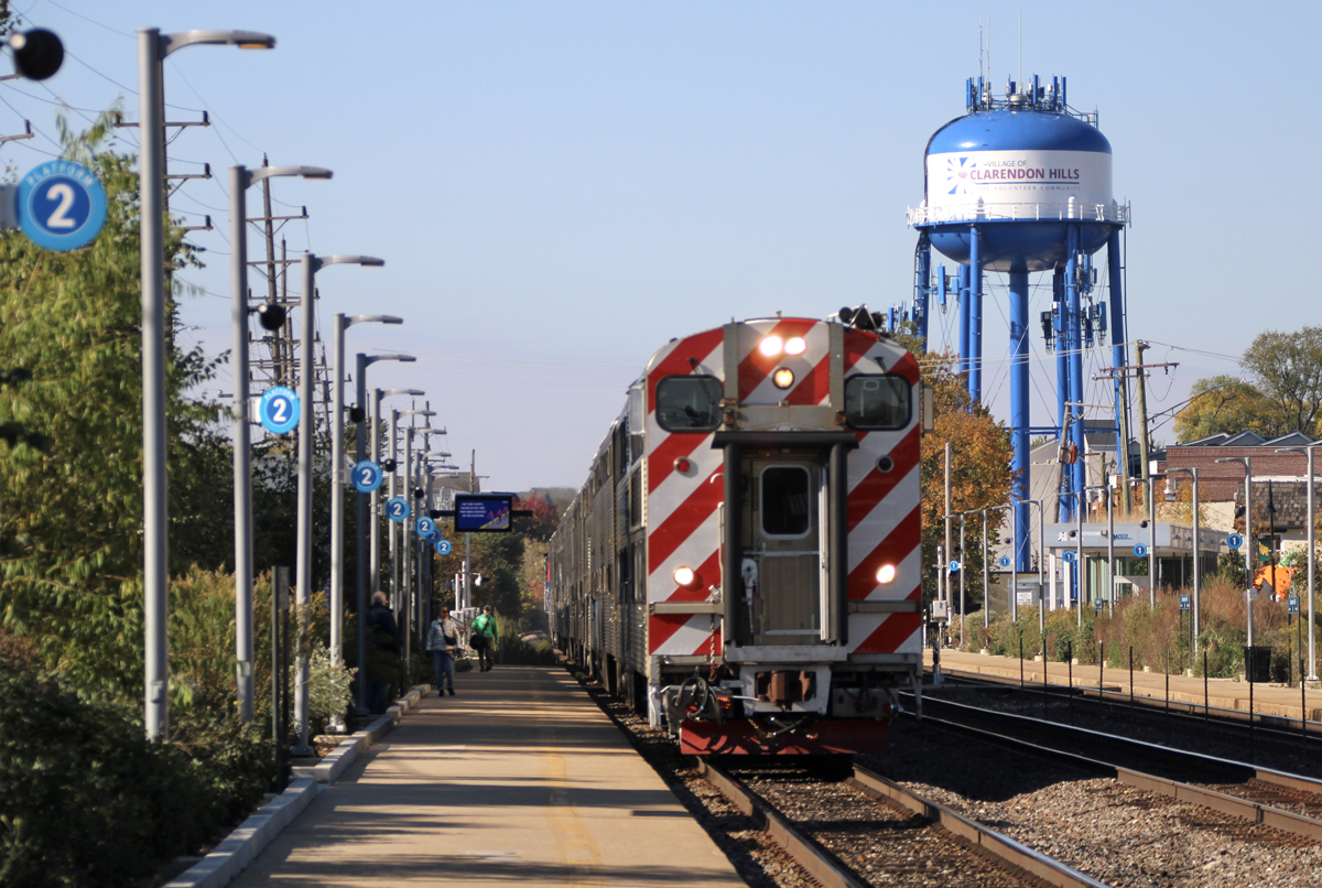 Commuter train with cab car leading arrives at station