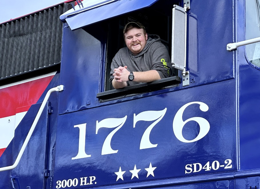 Smiling man in cab of locomotive