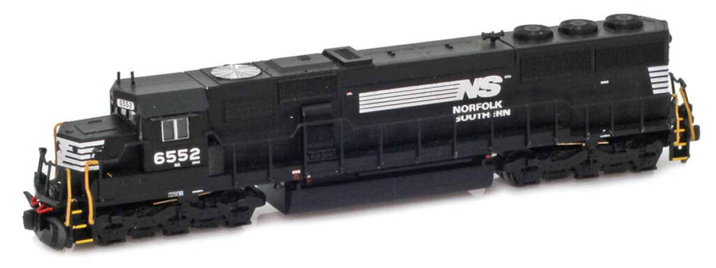 Color photo of Z scale hood unit painted black with white graphics and yellow step faces and vertical handrails on white background.