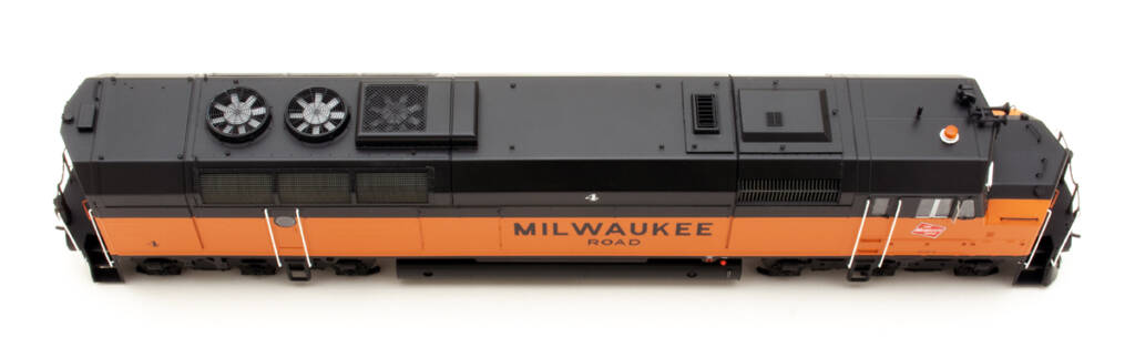 Color photo showing roof of HO scale cowl-body diesel painted orange and black on white background.