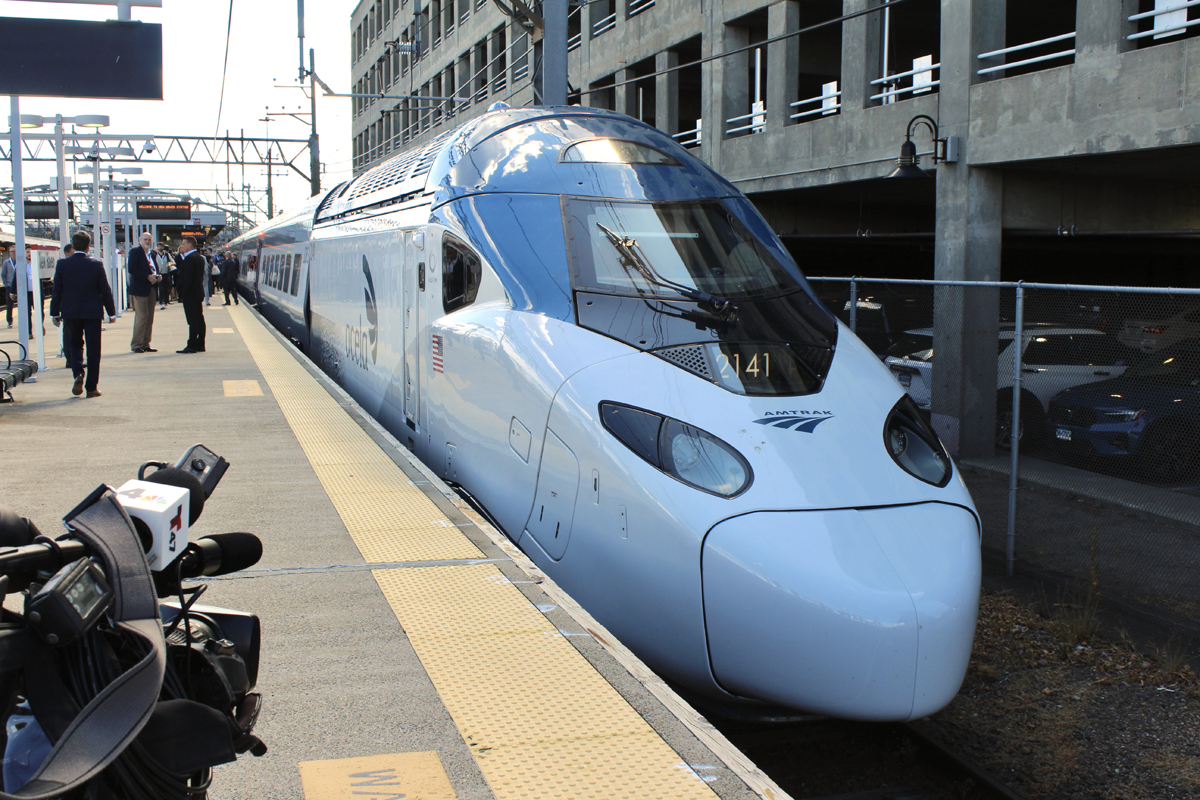Acela train at station platform with TV camera in foreground