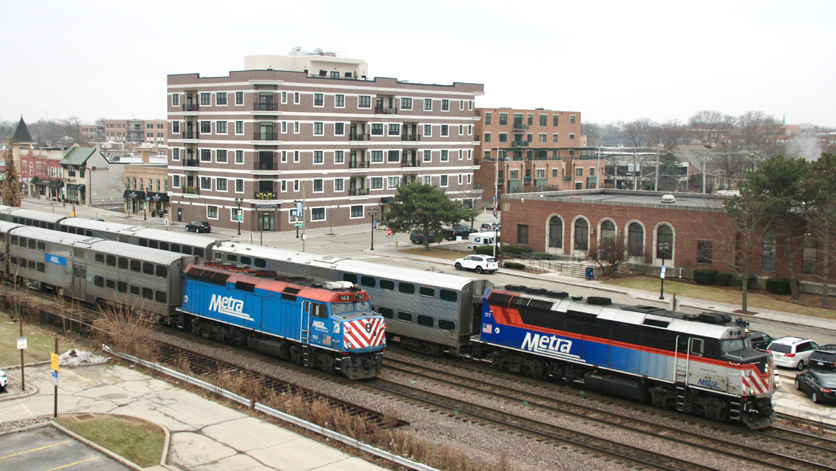 Two commuter trains side by side at suburban station