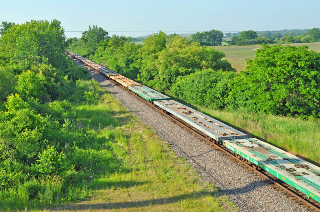 Overhead view of long string of flatcars