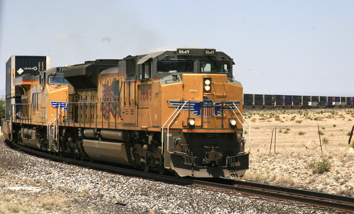 Intermodal train with yellow locomotives on sweeping curve