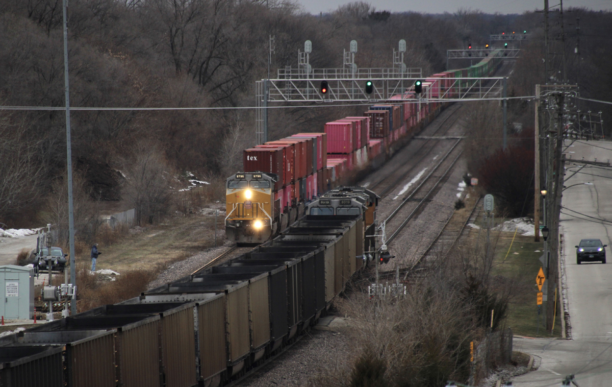 Elevated view of meet between container train and train of empty coal gondolas