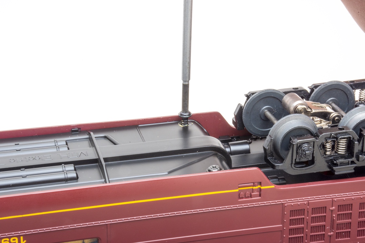 Removing body-mounted screws from underside of the frame