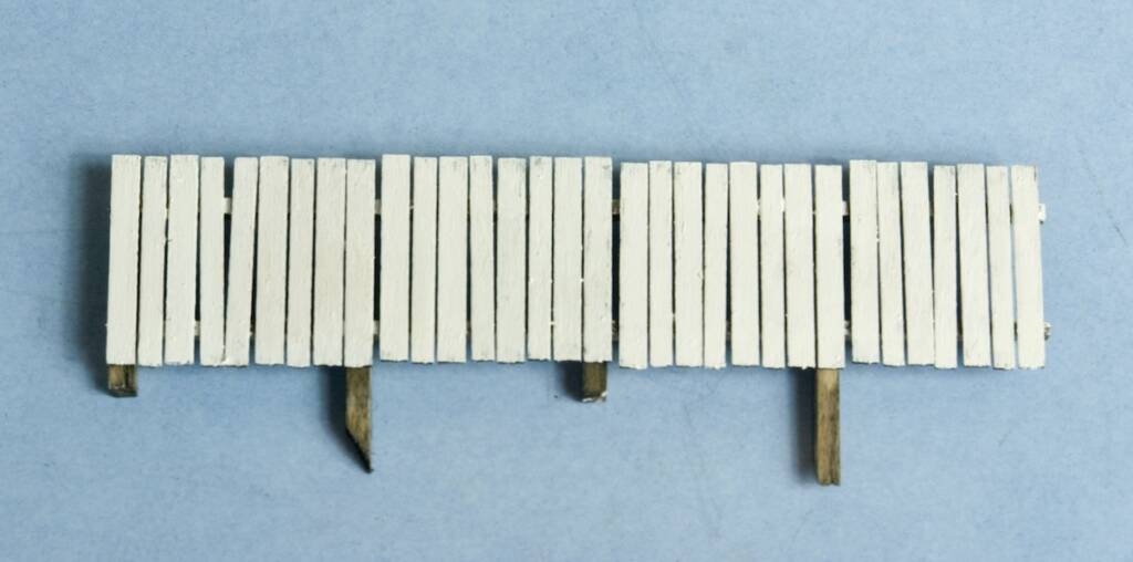 section of white painted model fence