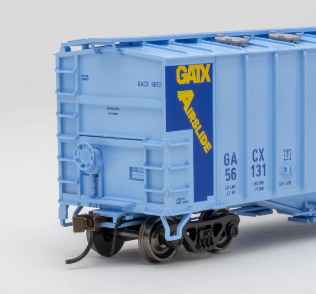 Color photo showing B end details on HO scale covered hopper painted two-tone blue with yellow, blue, black, and white graphics on white background.