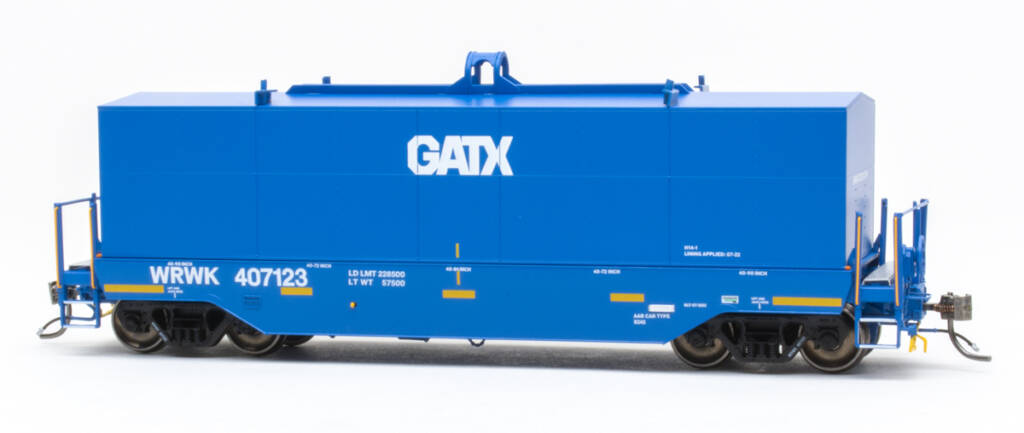 Color photo of modern HO scale coil car painted blue with white and yellow graphics and black trucks with metal wheelsets. 