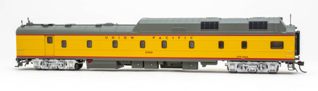 Color photo of HO scale power car painted Armour Yellow and Harbor Mist Gray with red graphics trimmed in black, silver trucks, and rooftop details on white background.