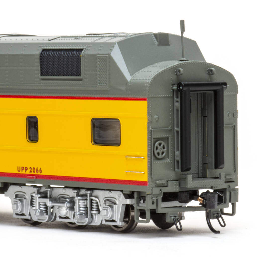 Color photo showing B end of HO scale power car painted Armour Yellow and Harbor Mist Gray with red graphics trimmed in black, silver trucks, and rooftop details on white background.