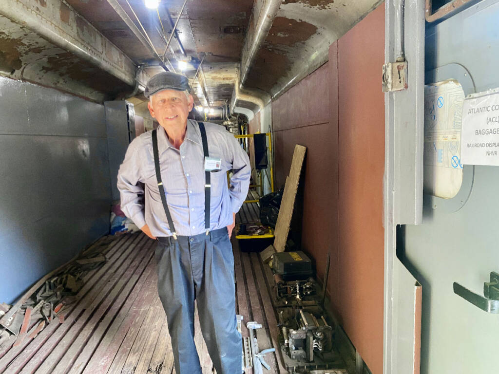 Man standing inside a baggage car. North Carolina Railroad Museum granted $280,000 for exhibits.