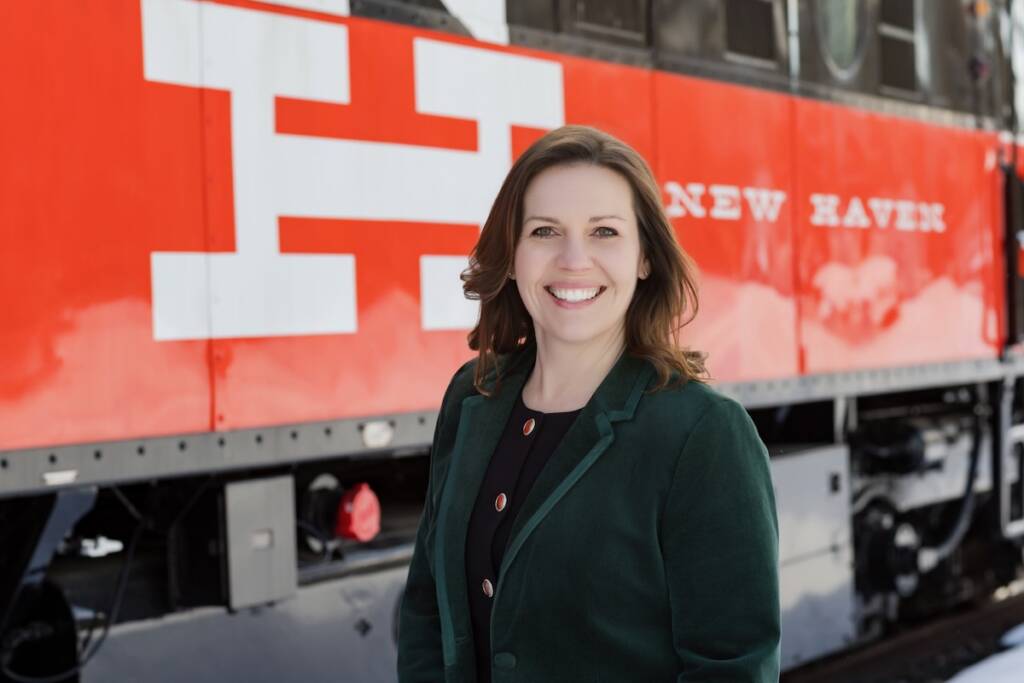 Woman standing in front of New Haven locomotive