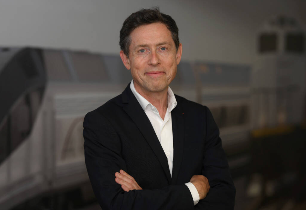 Man in coat and open-collar shirt