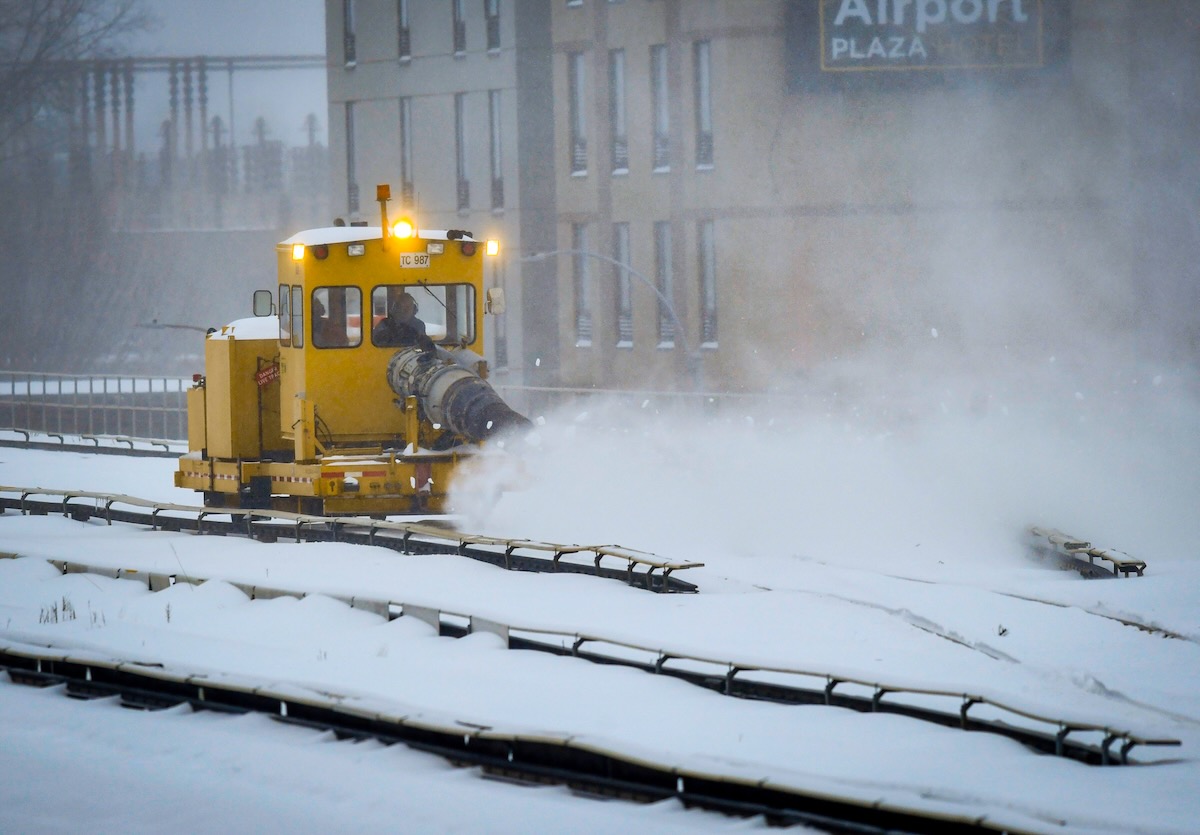 Snow blower clearing railroad tracks