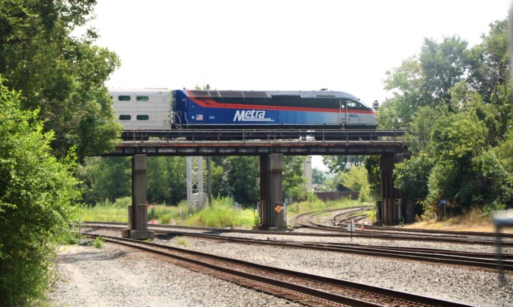 Commuter train on bridge over multiple railroad tracks