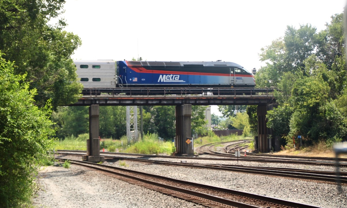 Commuter train on bridge over multiple railroad tracks