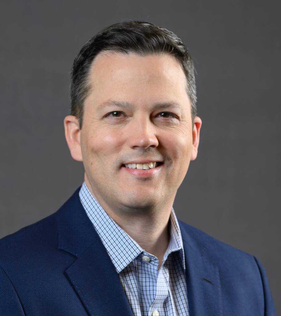 Head shot of man in coat and tie
