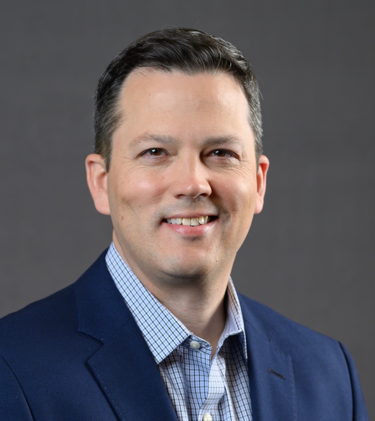 Head shot of man in coat and tie