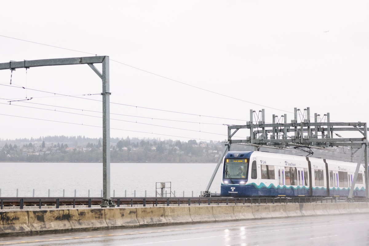 Light rail train on bridge shared with highway