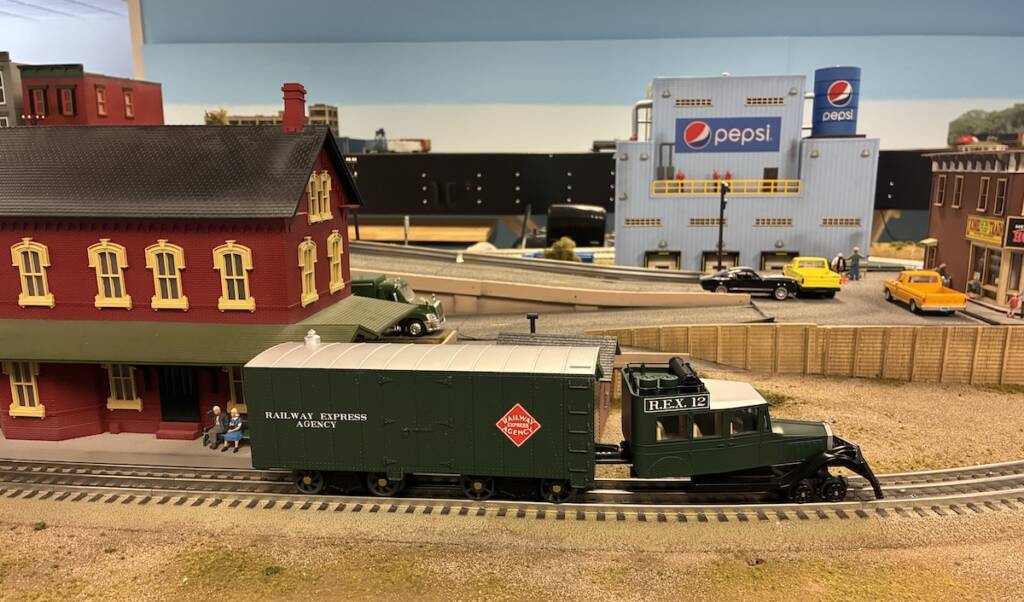 green and silver model railbus on layout