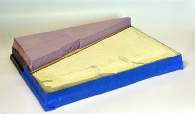 wooden base with pink foam insulation attached to a corner