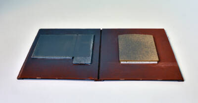 back of brick wall sections showing clear plastic window glazing misted with gray primer