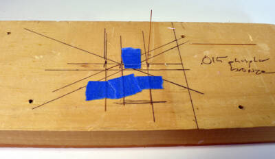 phosphor bronze wire is taped to a board after being soldered together to form a handrail