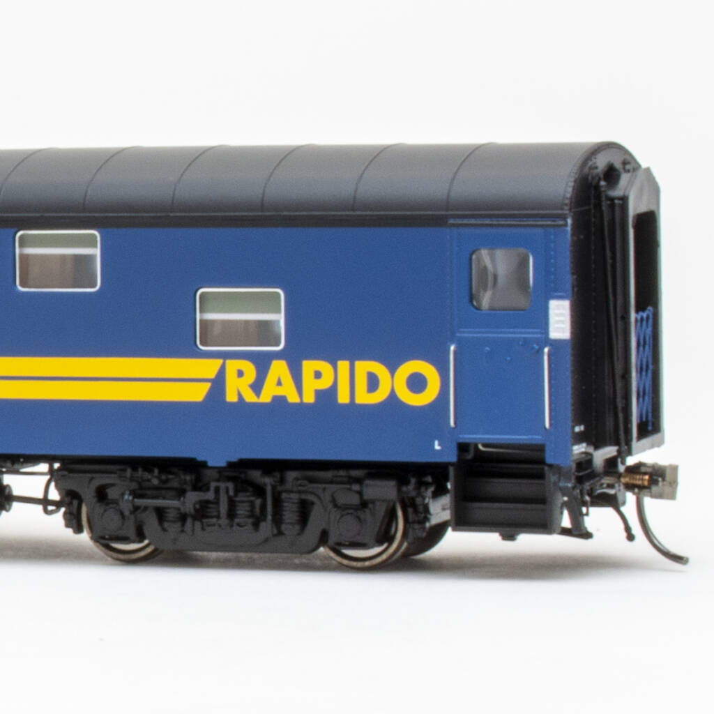 Color photo showing vestibule end of HO scale lightweight duplex sleeper painted blue, yellow, and black on white background.