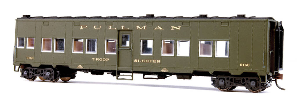 Color photo of Pullman HO scale troop sleeper painted dark green and black with gold lettering on white background.