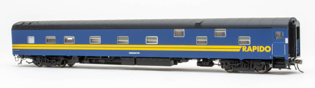 Color photo of HO scale lightweight duplex sleeper painted blue, yellow, and black on white background. 