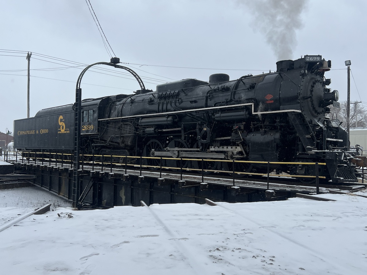Steam locomotive on a turntable during a winter afternoon.