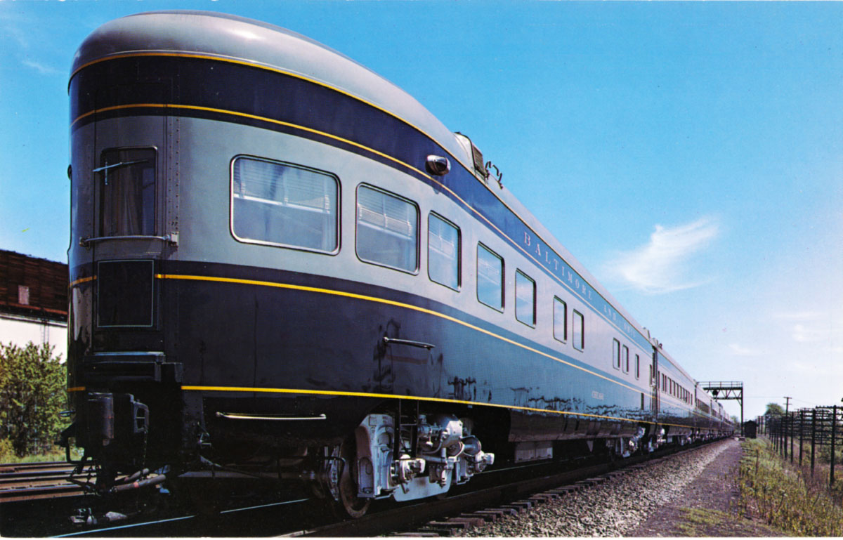 Blue and gray round-end observation car at the rear of a passenger train. B&O museum introduces restored 'Washington'.