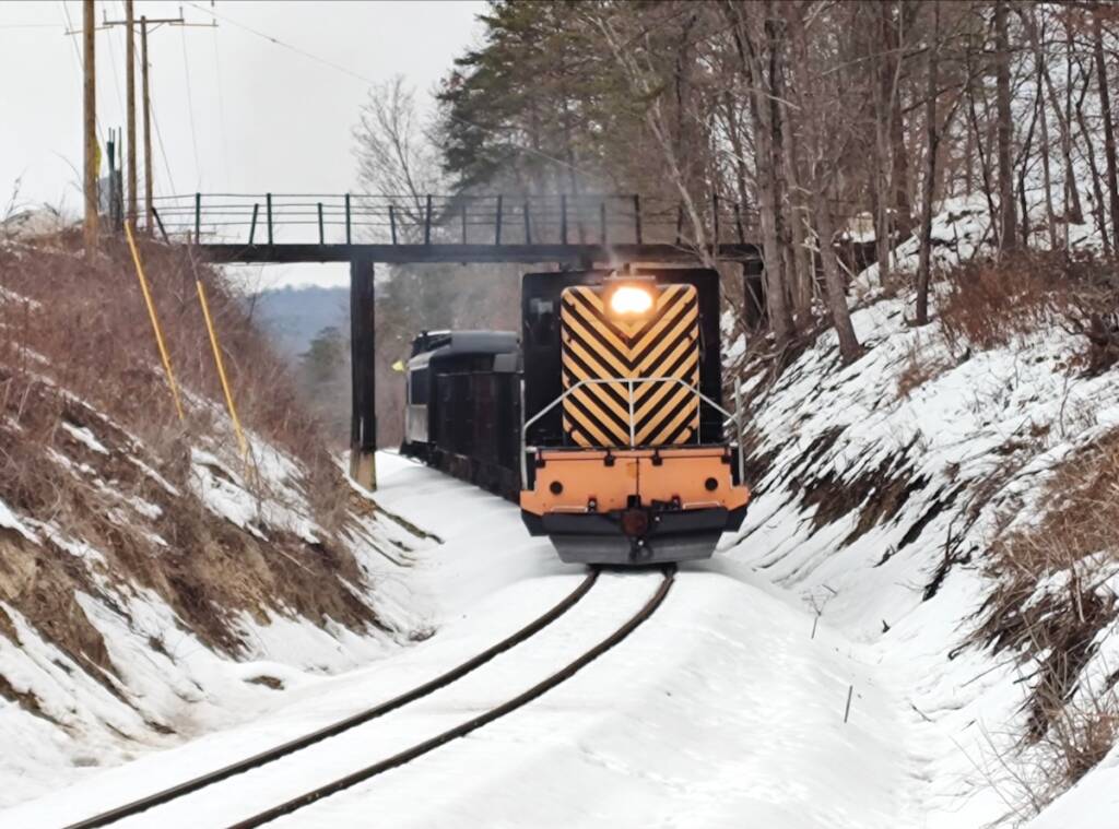 Diesel powered train passing under bridge