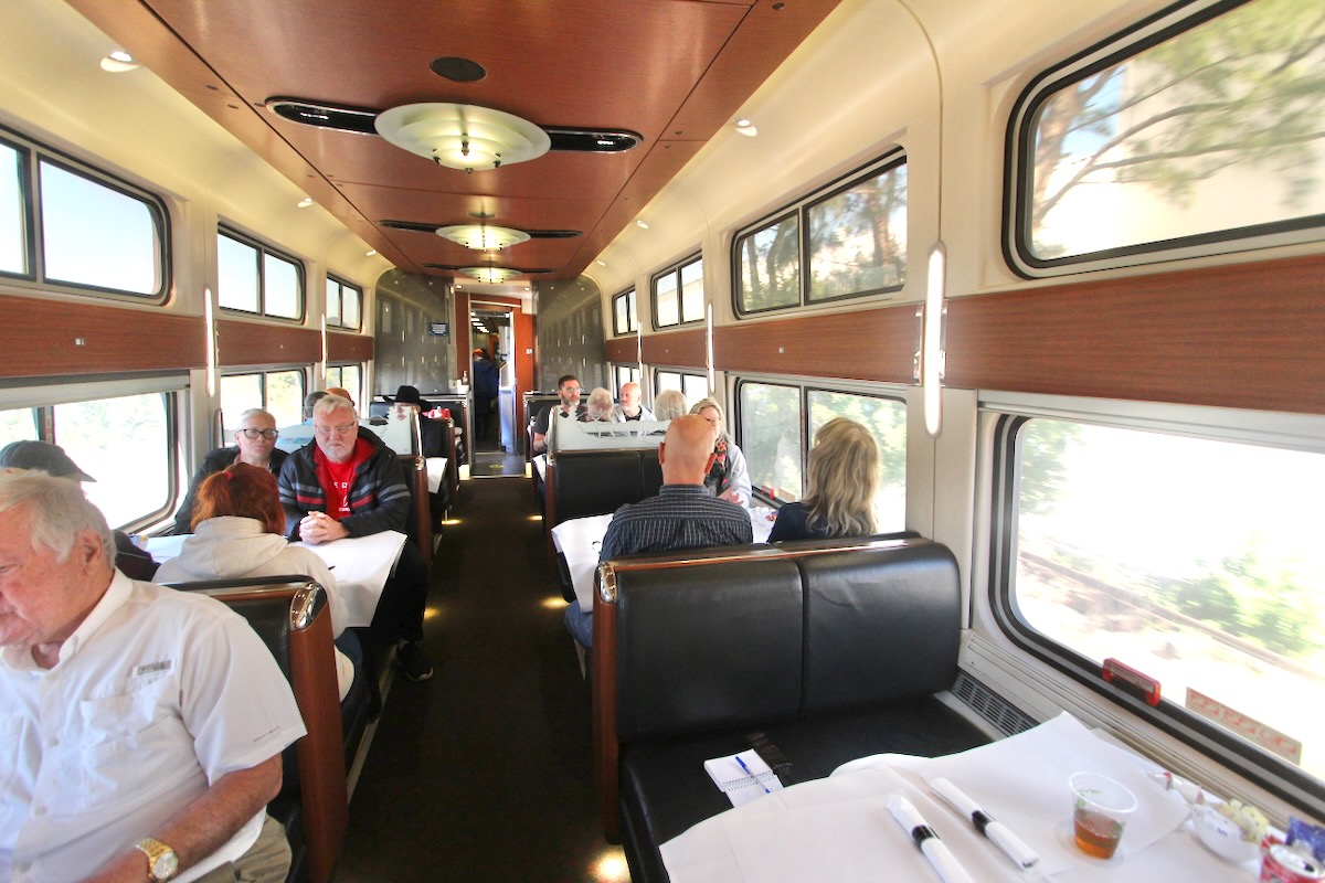 People eating in passenger-train dining car
