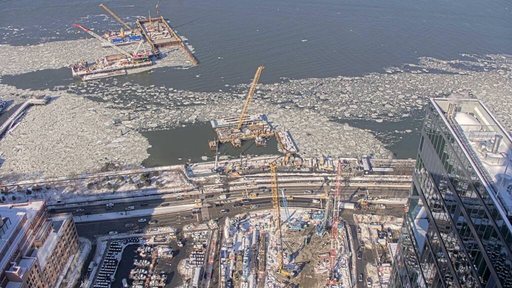 Aerial view of tunnel construction work along shore of Hudson River