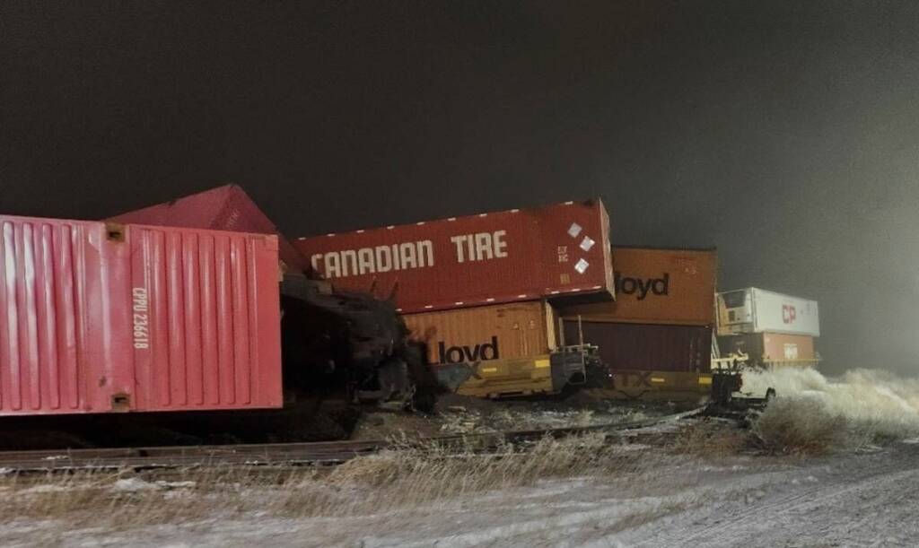 derailed freight train pictured at night