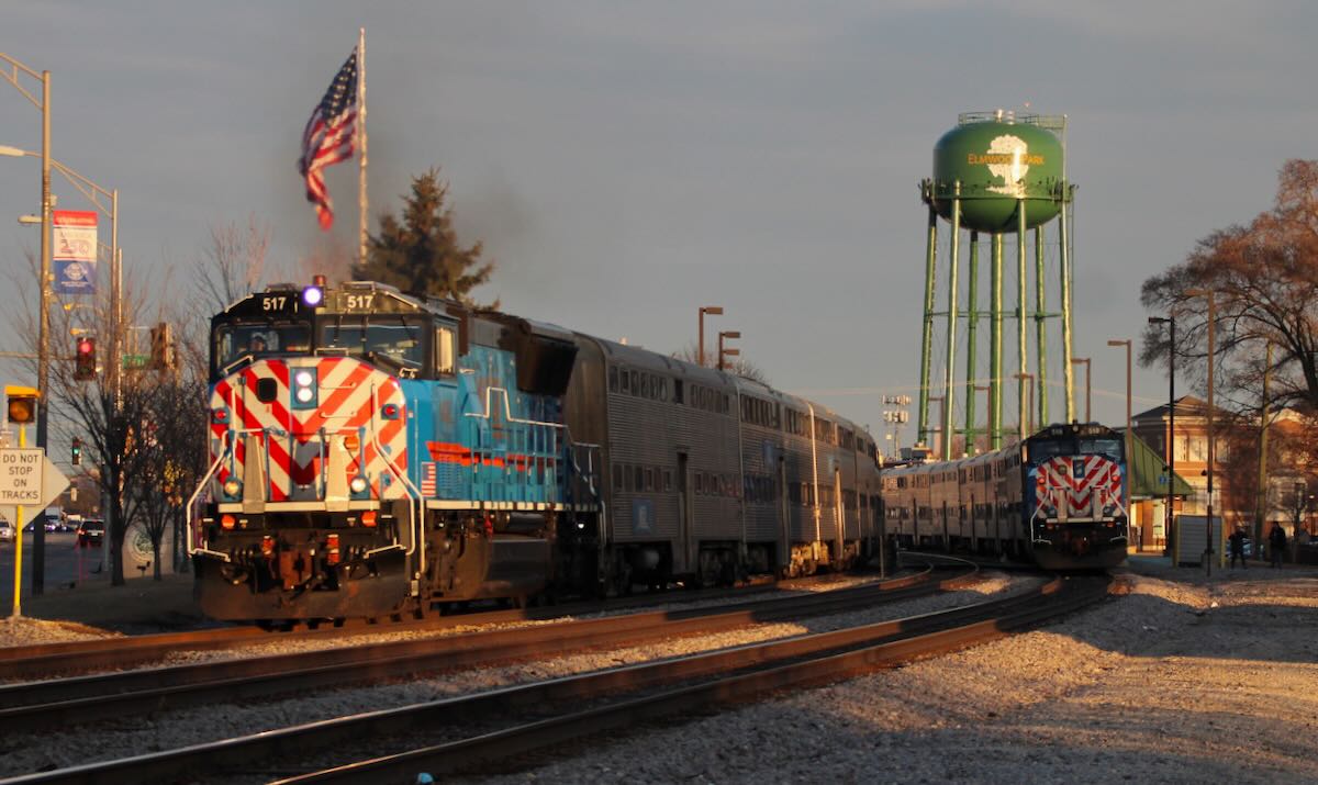Two commuter trains meet at station on curve