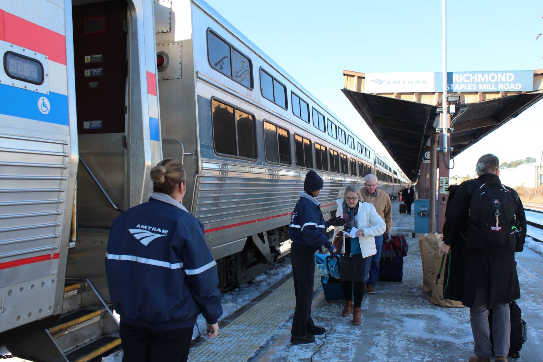 People boarding passenger train at station platform