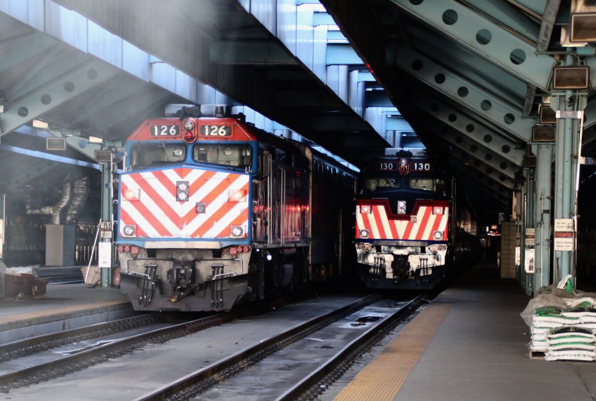 Two commter trains at station platform.