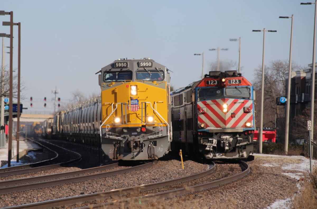 Freight and commuter trains side by side