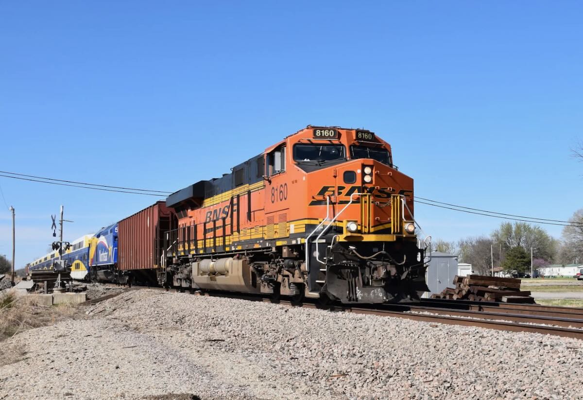 Freight locomotive with two hopper cars, two passenger locomotives, and eight commuter railcars