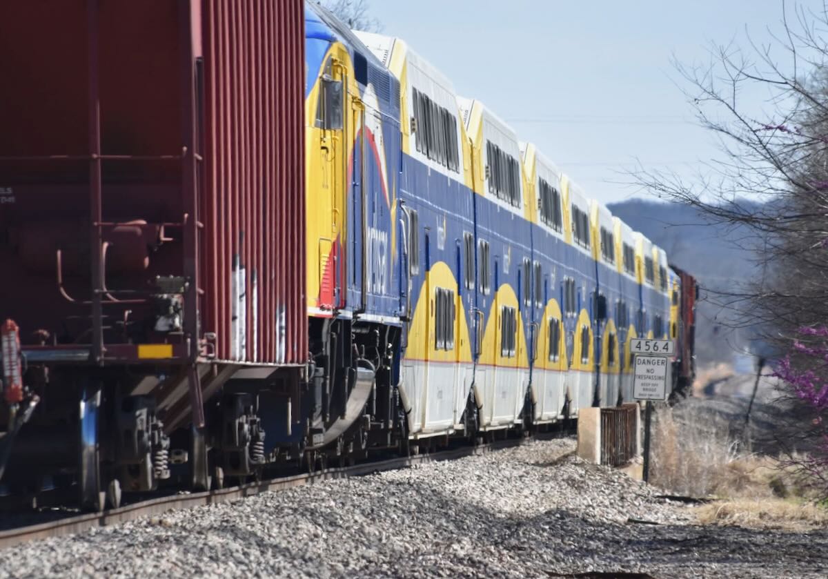 Going-away shot of train moving commuter equipment